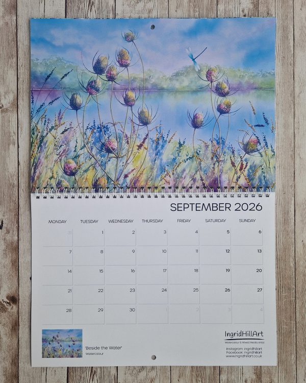 September 2026 calendar page with a watercolour painting of colourful teasels in front of still water.