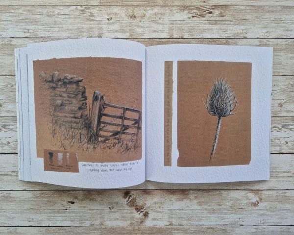 Two open pages from a book showing a rustic gate and a teasel seed head drawn on brown paper.
