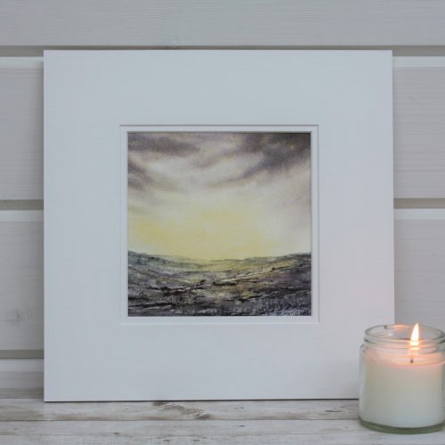 Golden Dawn a mounted painting of a sunrise with a candle in front.
