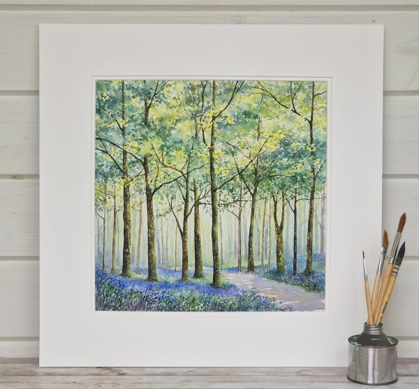 Painting of a path through a bluebell wood presented in a square mount.