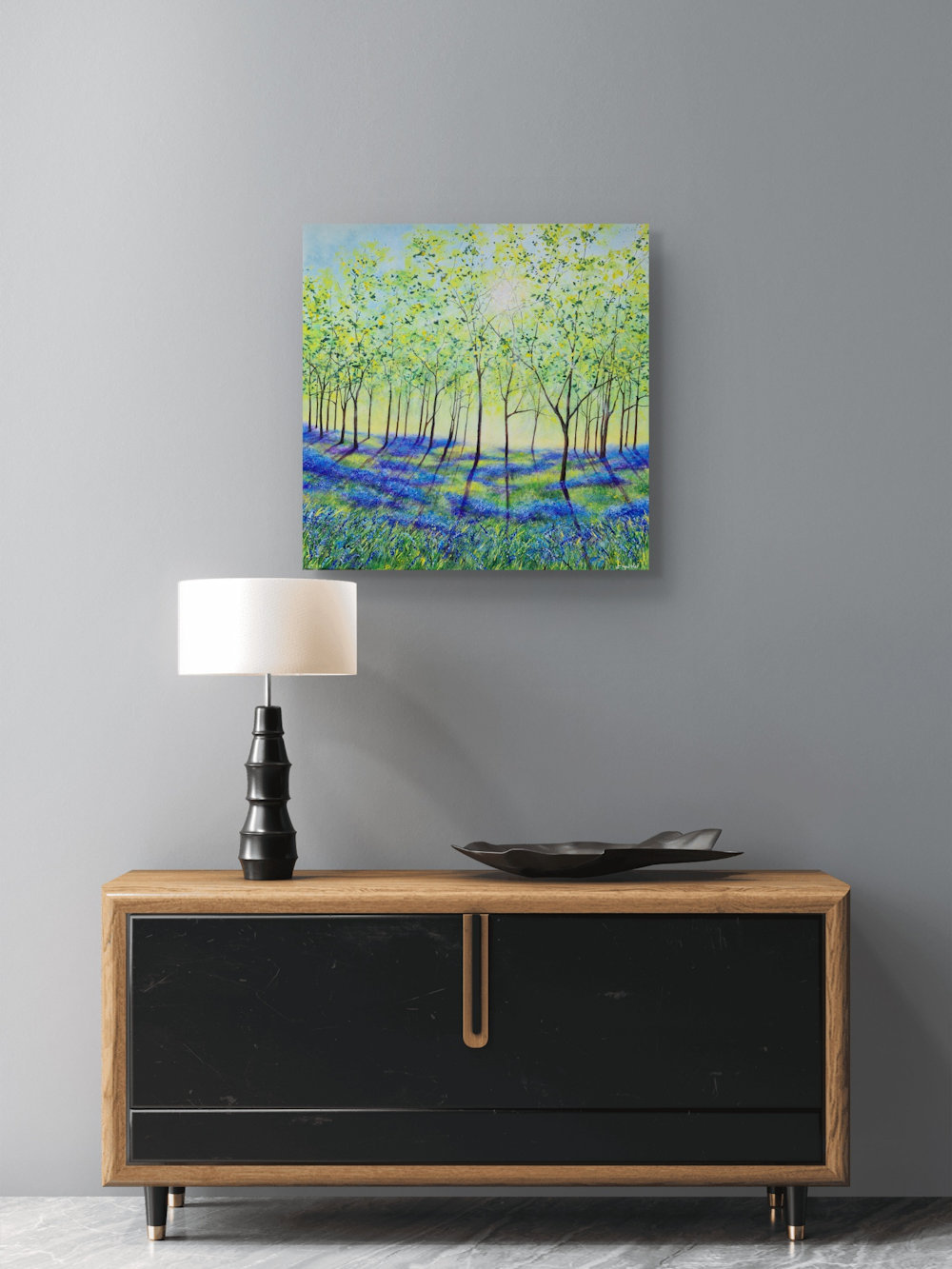 Light Dances on Bluebells is a canvas painting shown in a room setting.